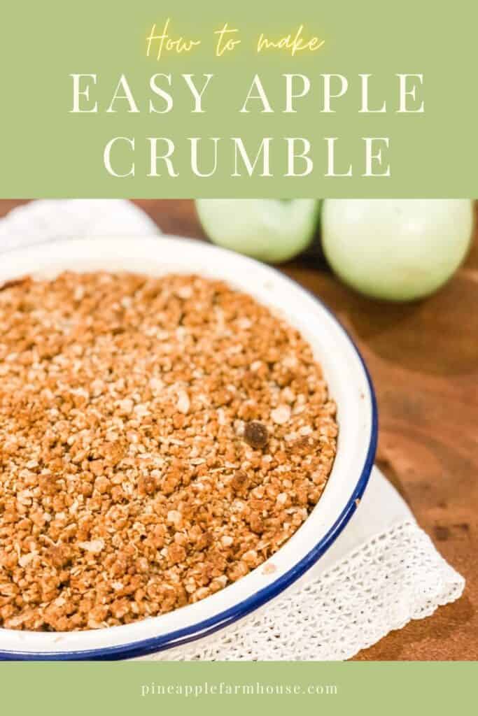 graphic with an image of apple crumble in a blue and white pie dish next to three apples set against a wooden table with crochet linen and text "how to make easy apple crumble" and the pineapple farmhouse website address