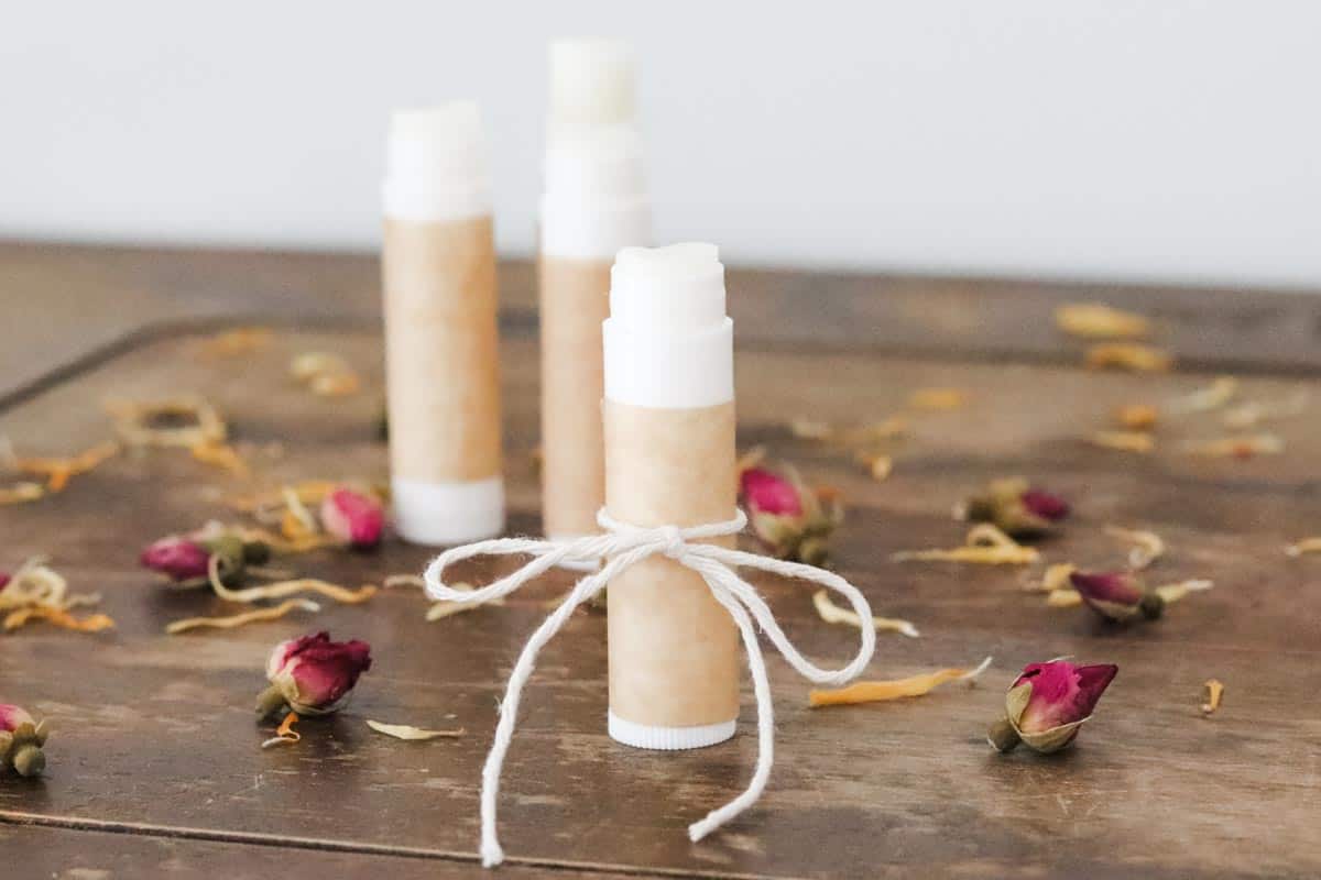 Image of a group of lip balm tubes filled with DIY essential oil lip balm, wrapped in brown paper and cotton string