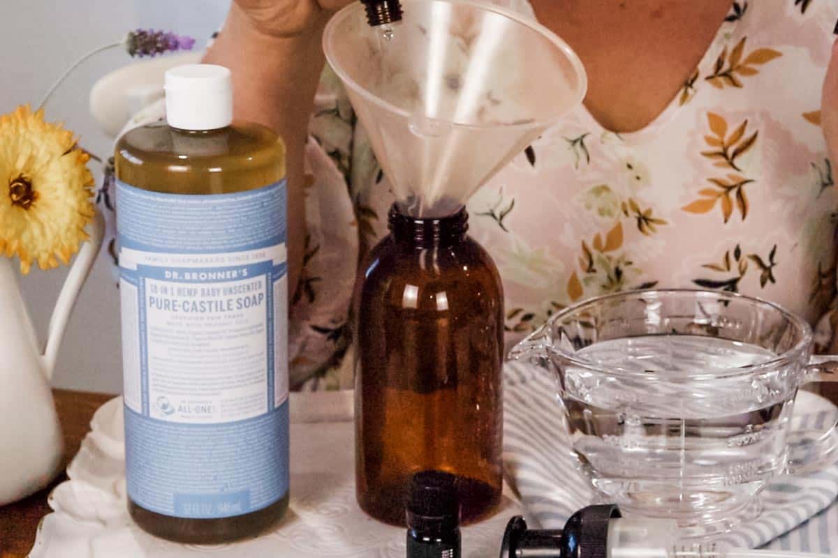 Image of essential oils being poured into the dispenser through a funnel