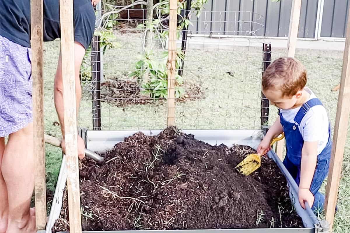 William and Justin turning over the soil in the garden bed