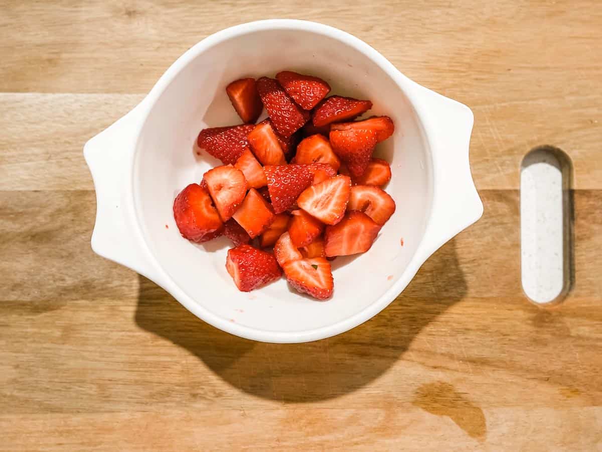 Overhead image of chopped strawberries in a microwave safe dish