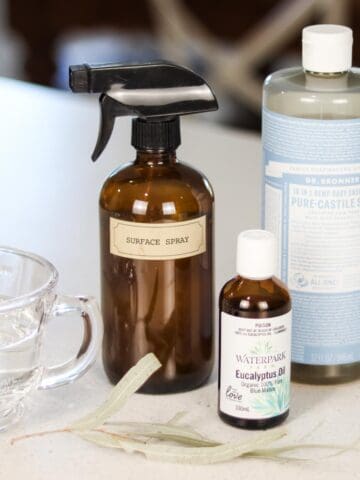 Image of a group of ingredients used to make eucalyptus cleaning spray: water , eucalyptus essential oil, liquid castile soap