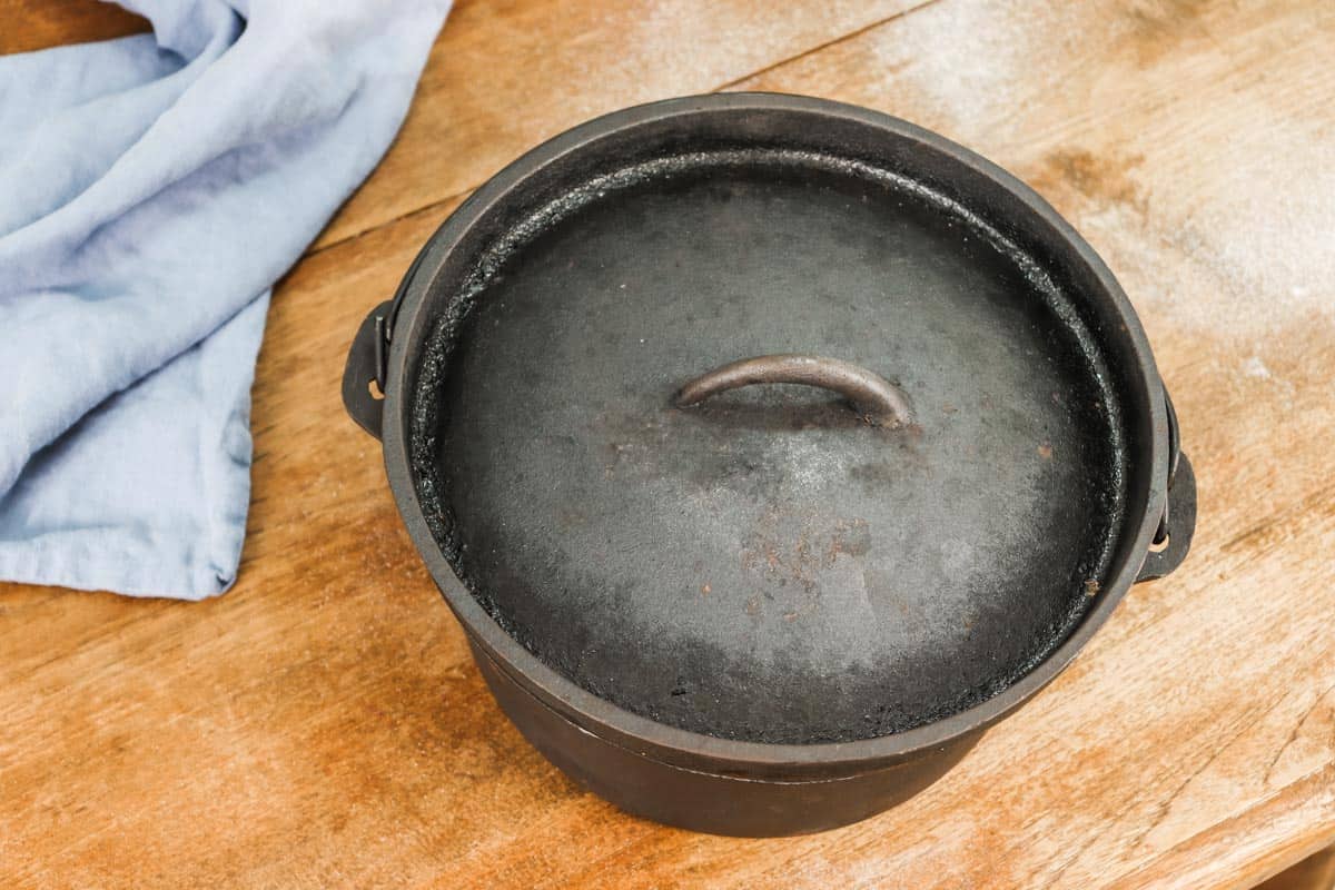 A black cast iron dutch oven with a lid