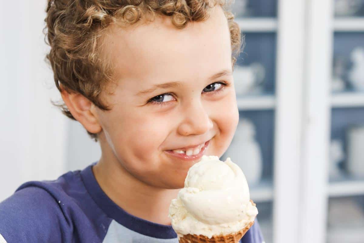 William eating an ice cream cone and smiling