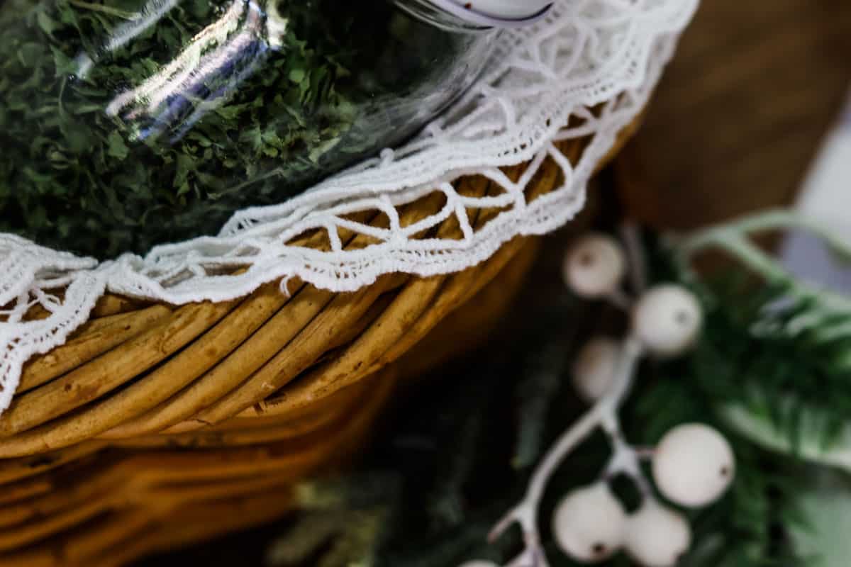 A Christmas gift hamper basket lined with crocheted fabric