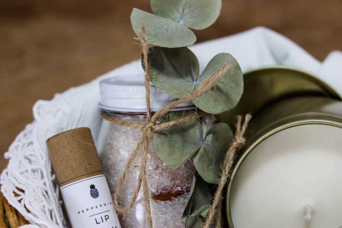 A dried stem of eucalyptus is used to embellish a jar of homemade bath salts