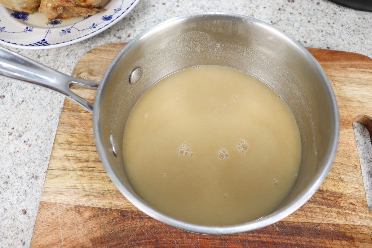 the stock has been added to the browned flour and pan juice mixture in the saucepan