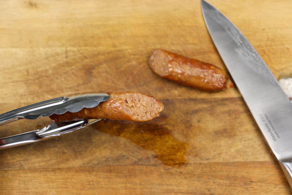 A sausage has been cut to check it is done