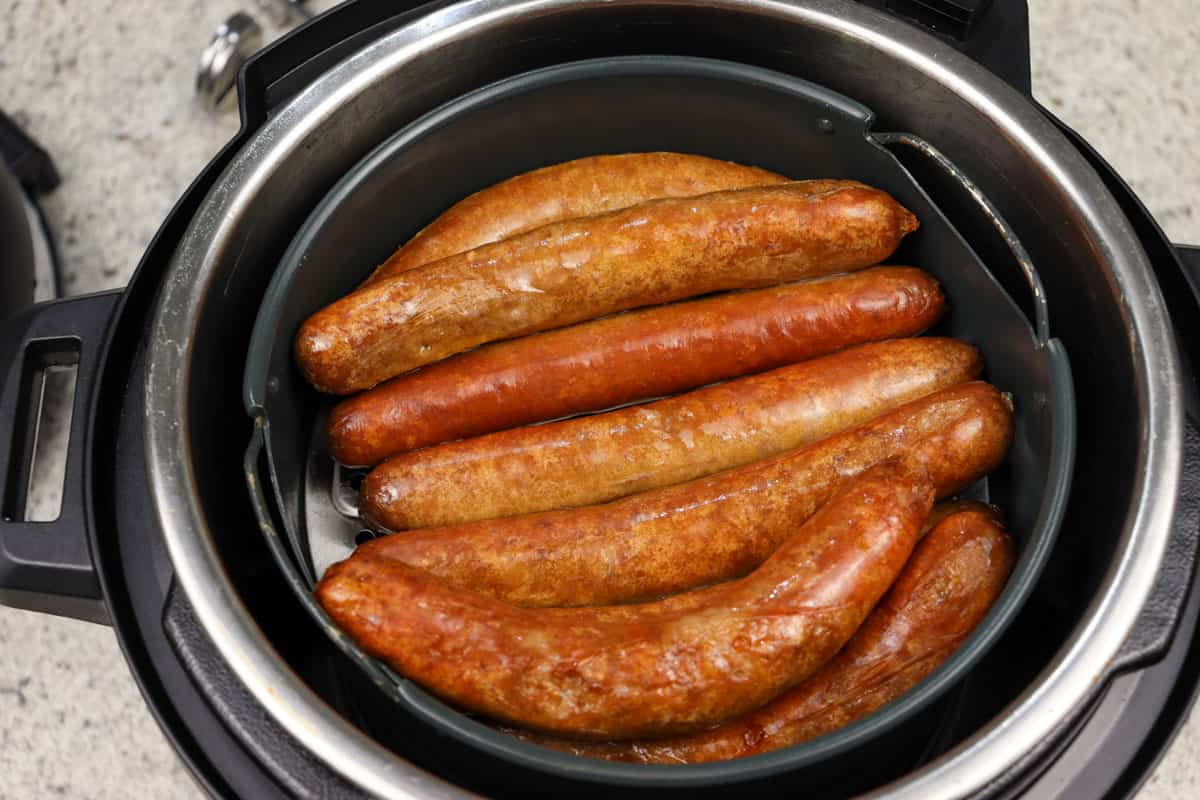 Cooked sausages ready to be taken out of the air fryer