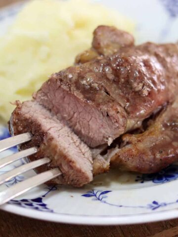 A pork steak is sliced open on a plate