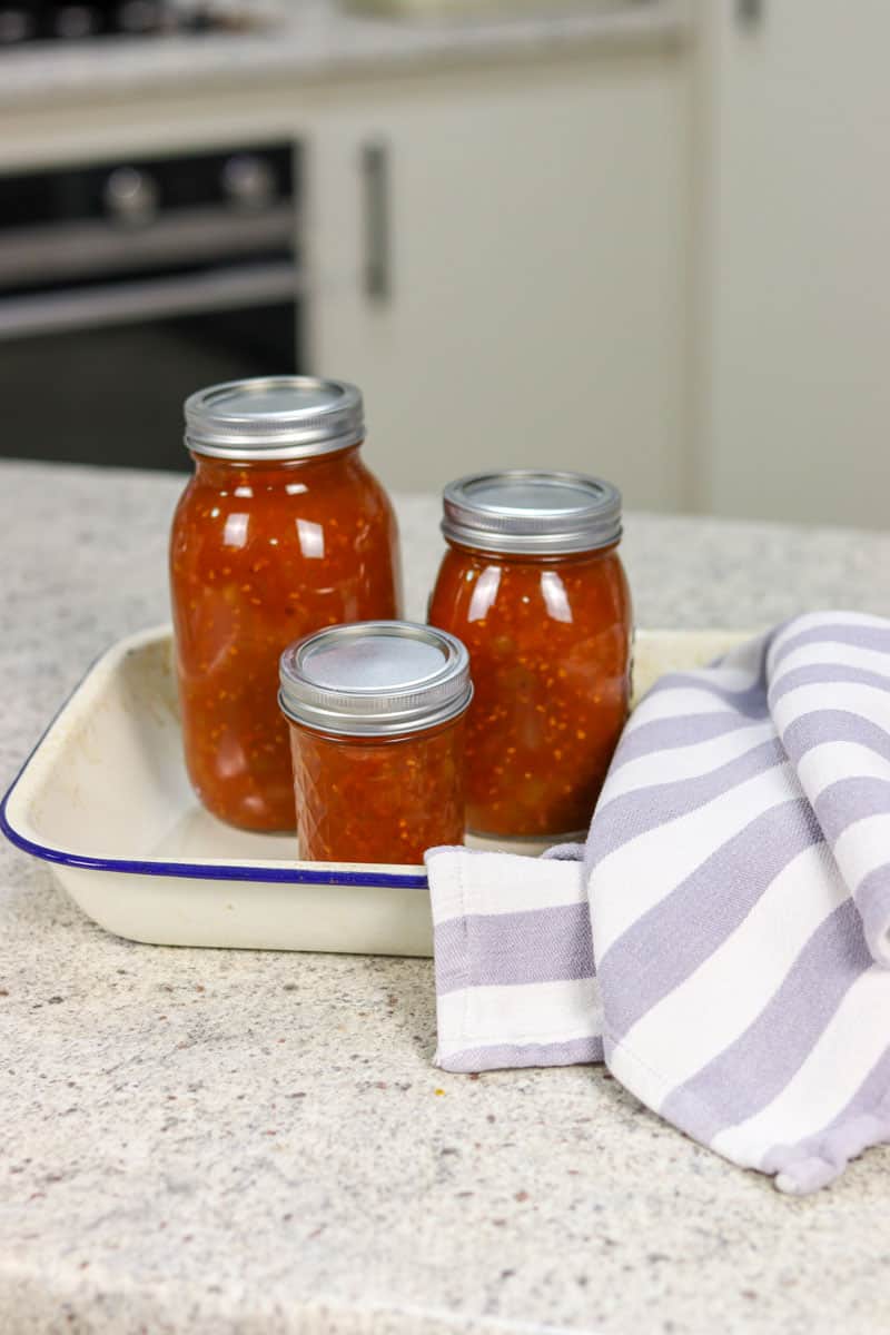 Three sealed jars of tomato relish after canning