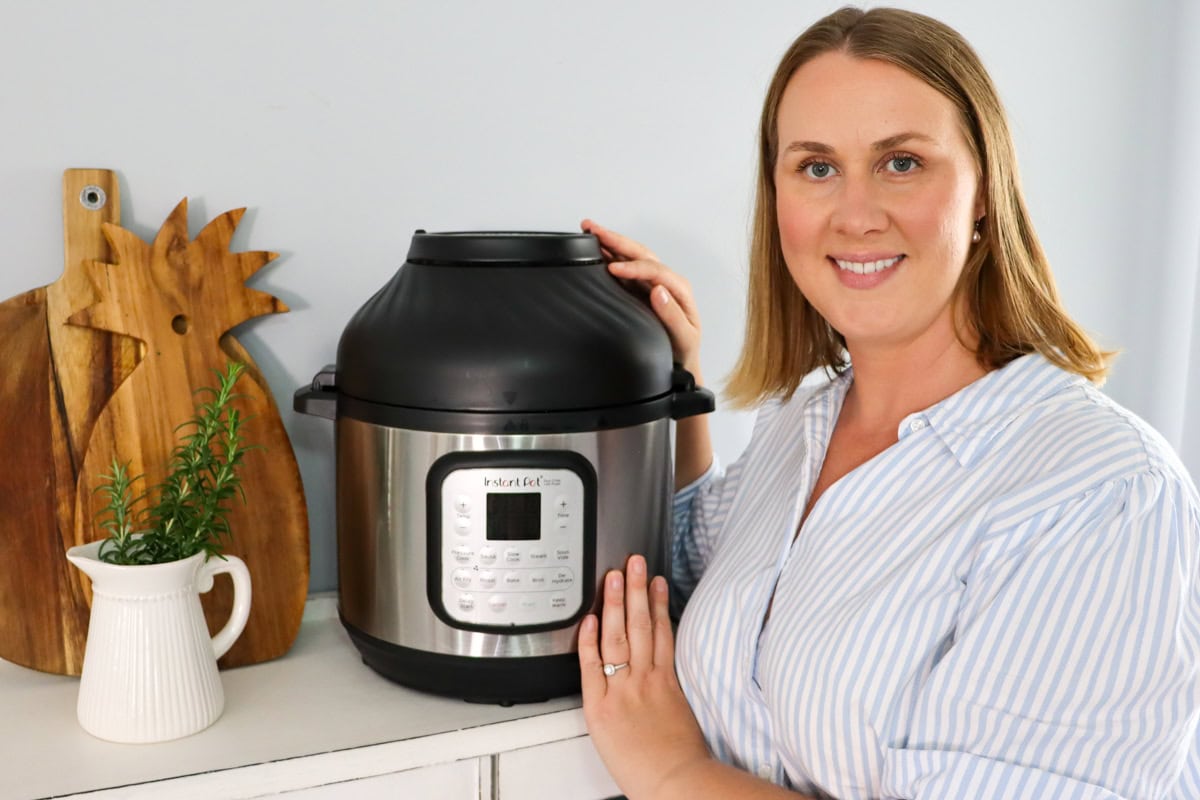 Emily poses next to her non toxic air fryer