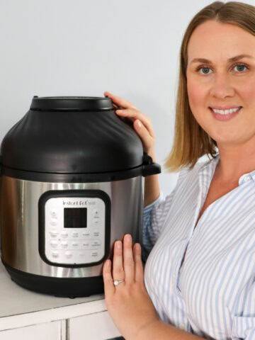 Emily poses next to her non toxic air fryer