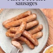 Graphic for Pinterest showing text "quick and easy air fryer sausages" and a image of cooked sausages on a plate with a fork and bowl of mustard