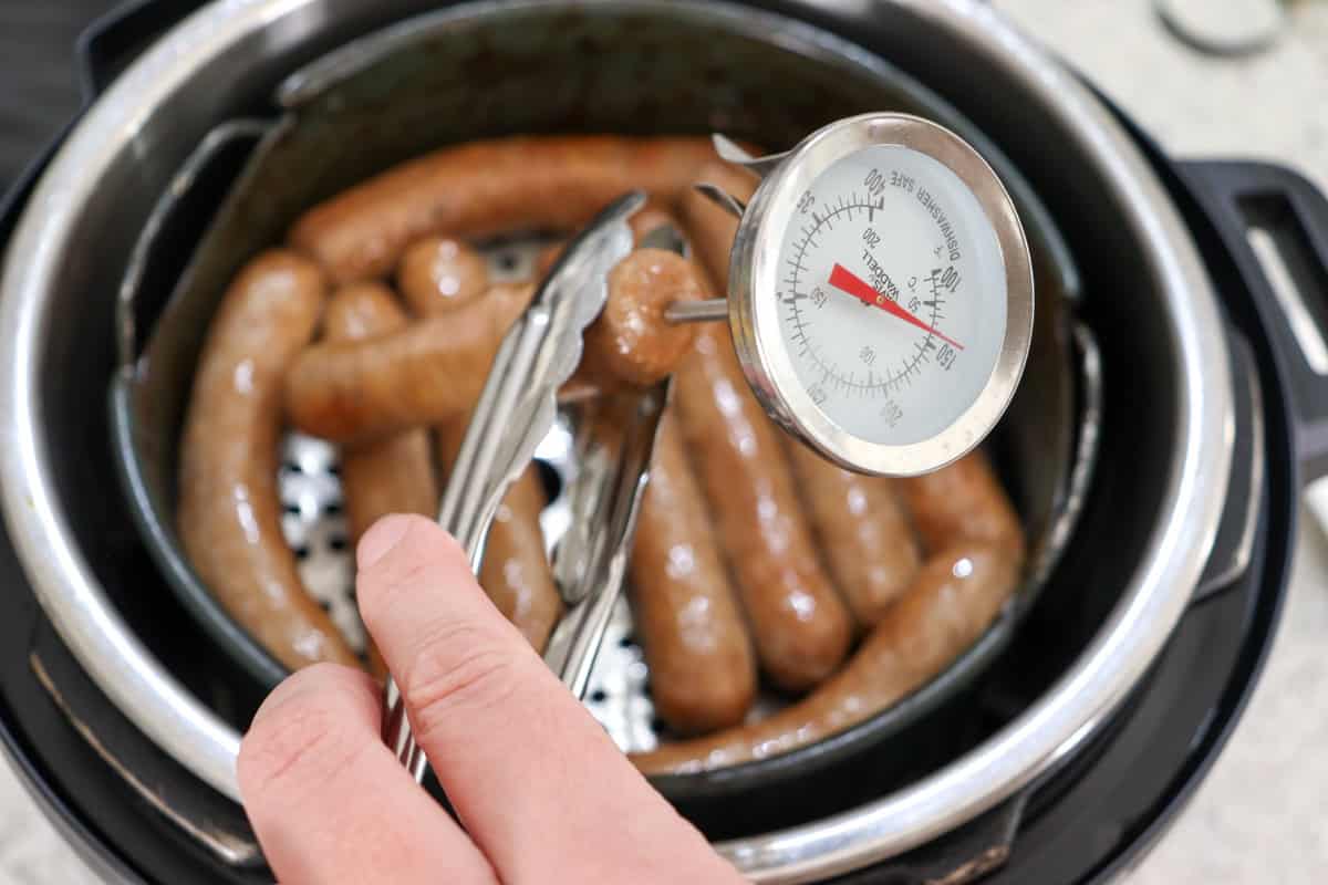 At the end of the cooking time a meat thermometer is inserted into the sausage to check the internal temperature