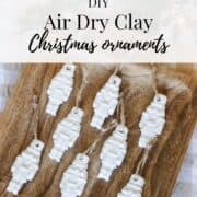 Graphic for Pinterest with an image of air dry clay Christmas ornaments on a wooden tray with text "DIY air dry clay Christmas ornaments"