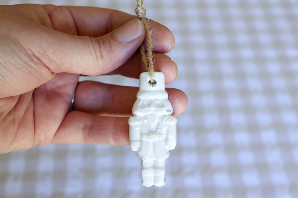 Twine is threaded through the hole to make a loop to hang the ornament