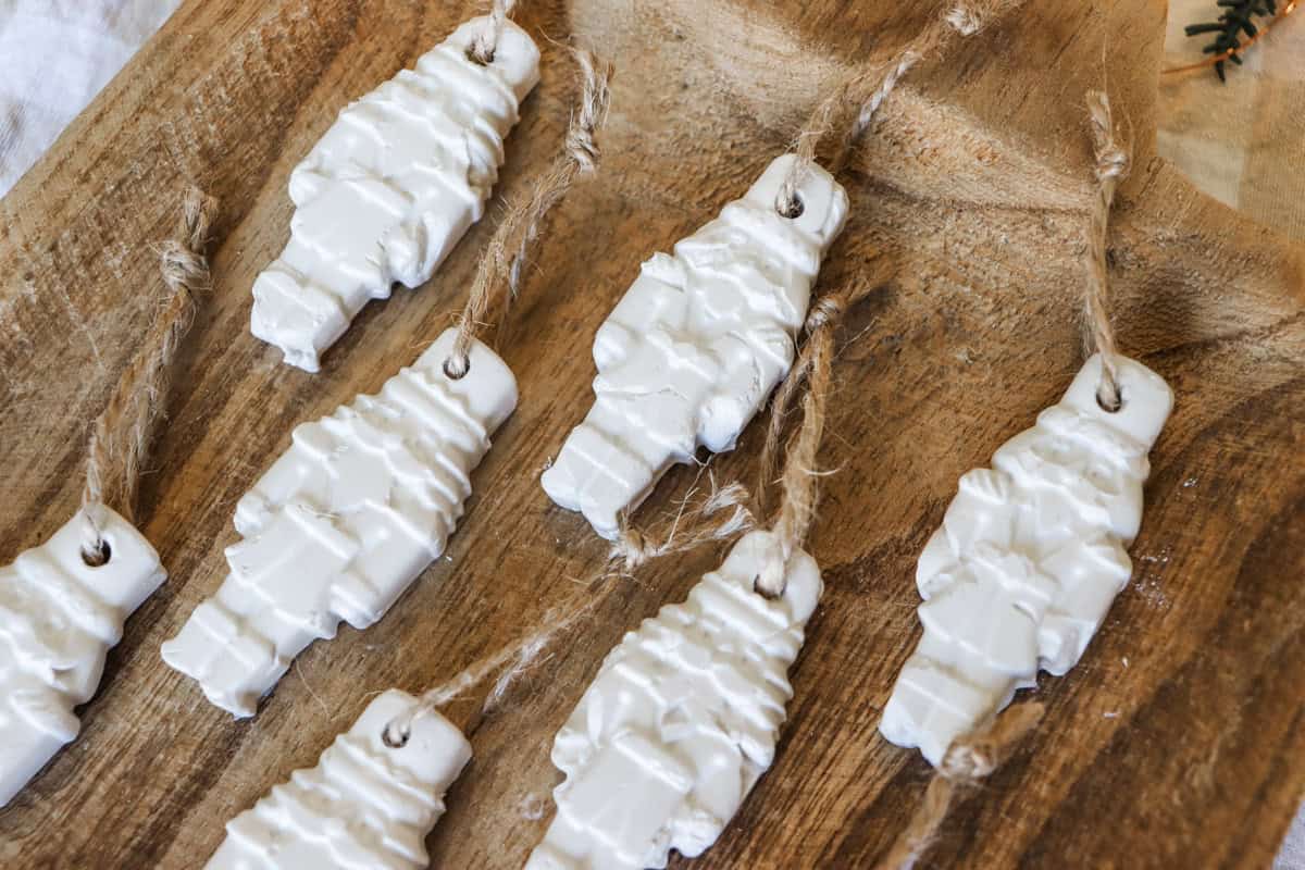 Air dry clay nutcracker Christmas ornaments on a wooden tray