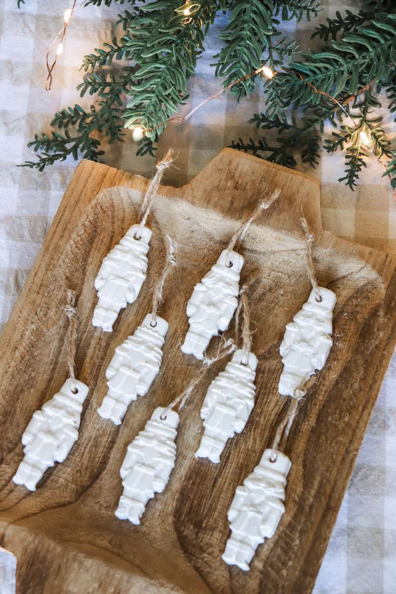 Air dry clay nutcracker Christmas ornaments on a wooden tray