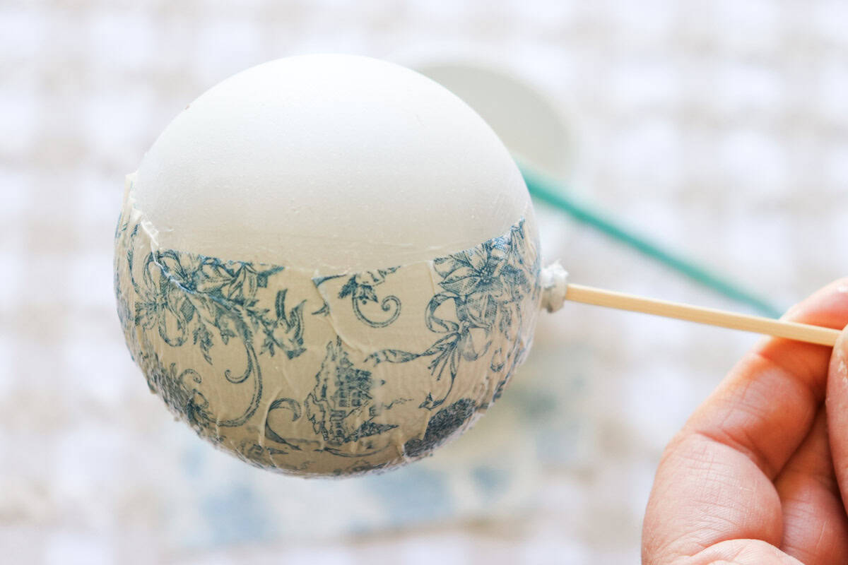 A skewer is inserted into the bauble