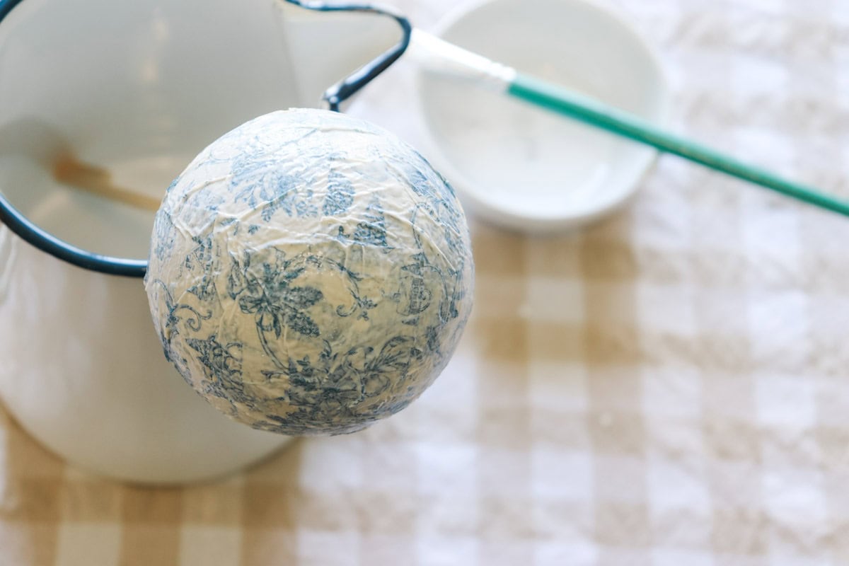 The bauble is fully covered and drying on the skewer