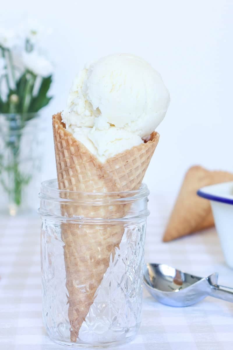 Ice cream served in a cone sitting in a glass jar