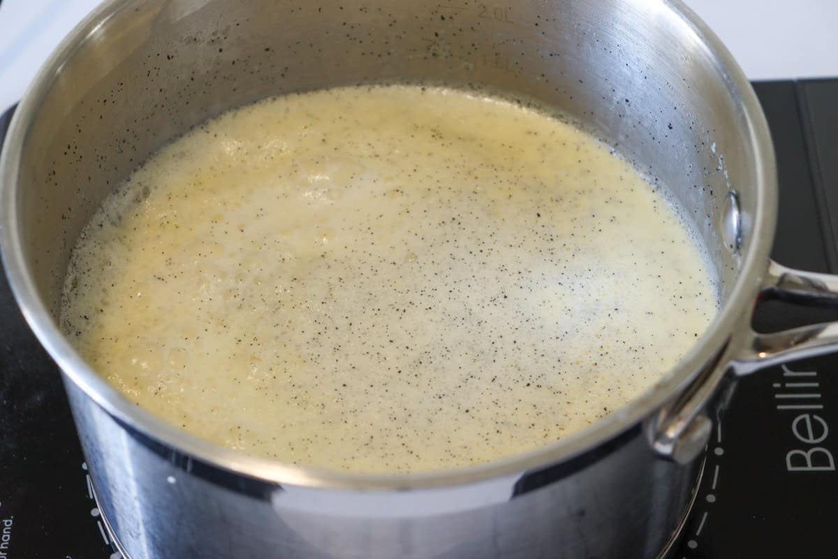 The cream, milk and vanilla is simmered in a saucepan over low heat