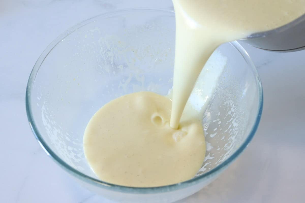 The custard is poured into a bowl before chilling