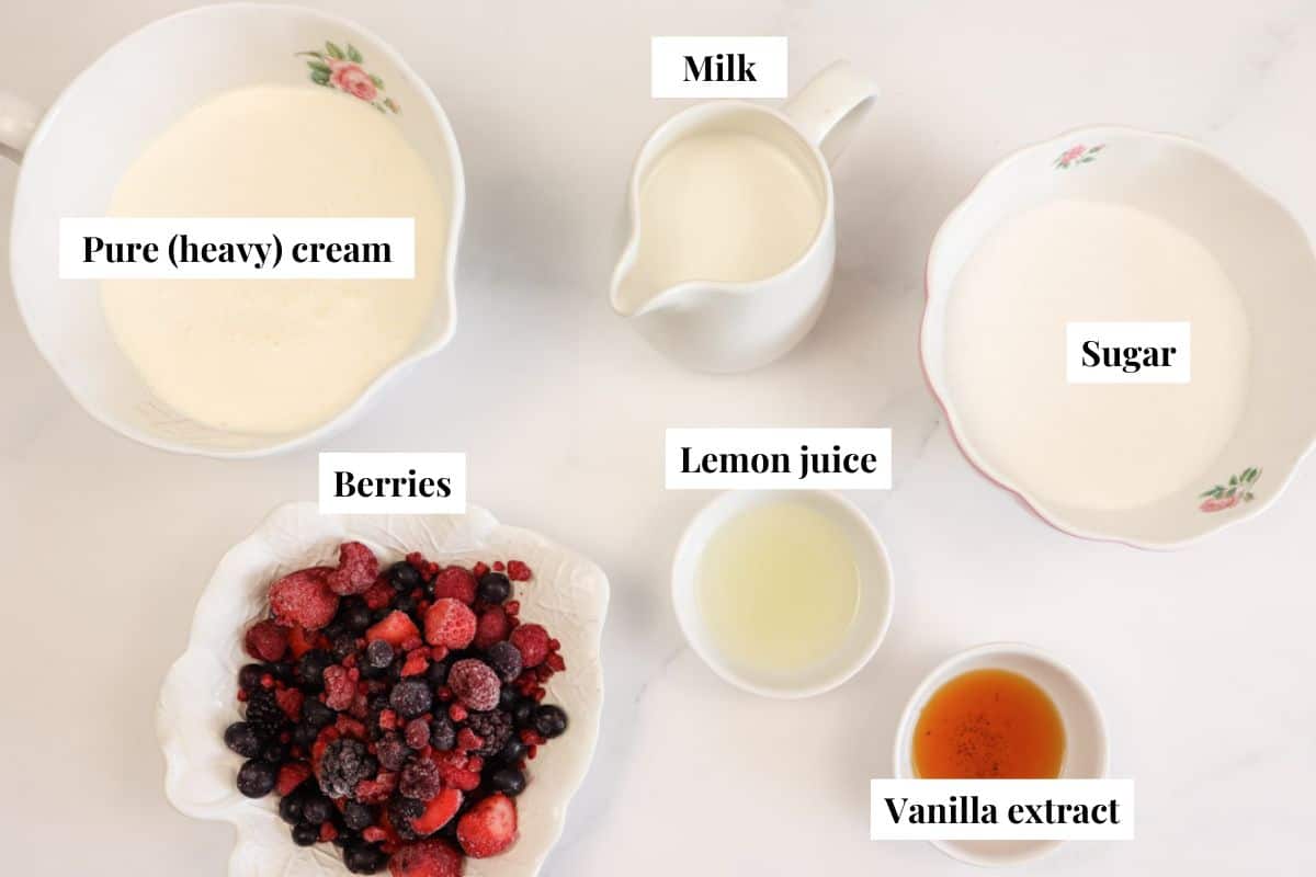 ingredients to make homemade berry swirl ice cream including pure (heavy) cream, milk, lemon juice, berries, sugar and vanilla extract