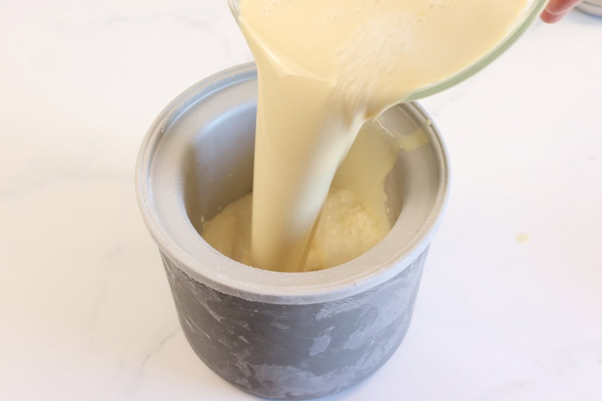 The ice cream mixture is poured into the freezer bowl of the ice cream maker