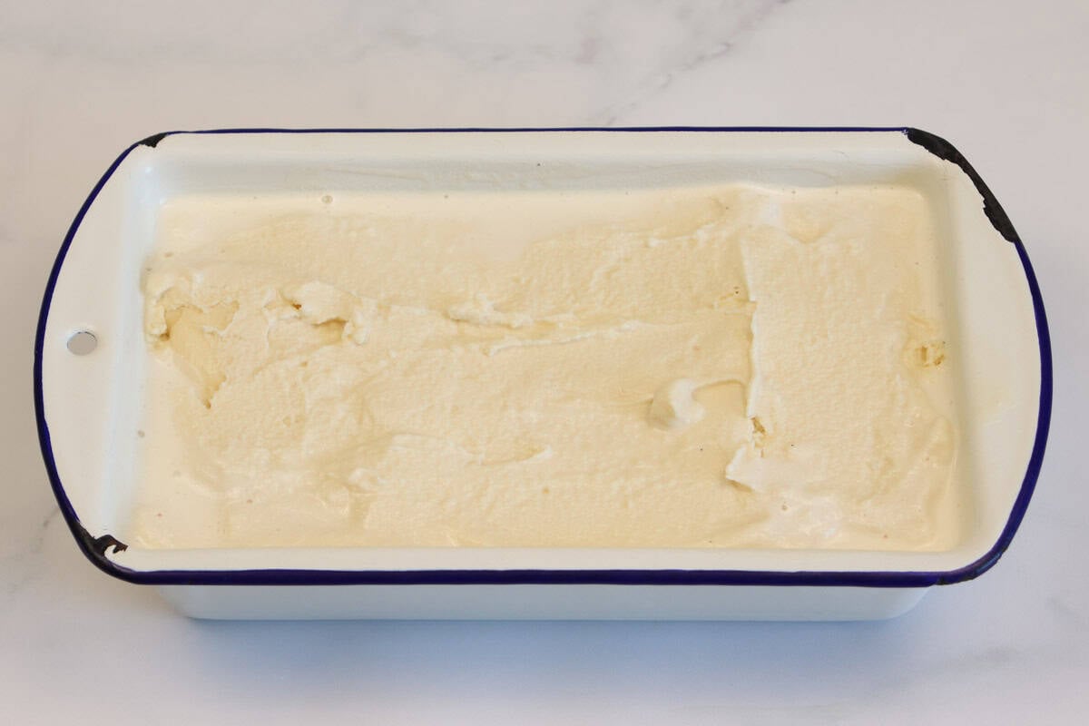 The churned ice cream is in the container ready to be frozen