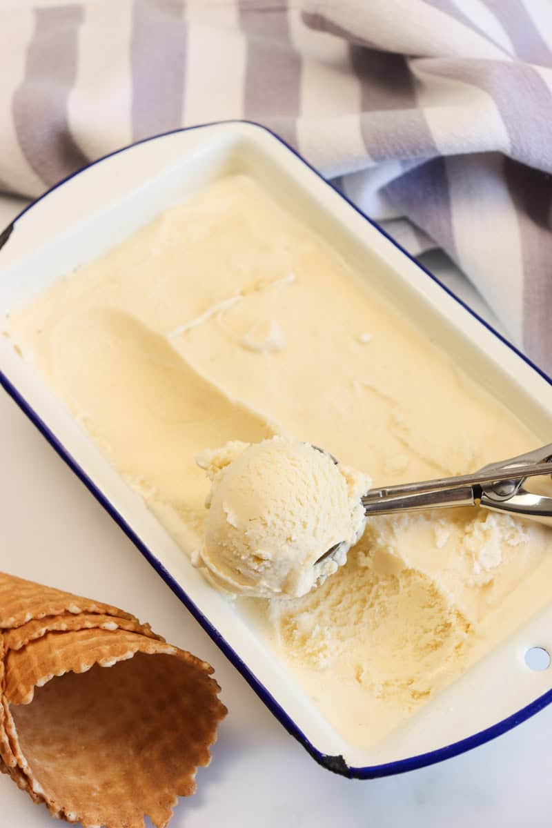 Ice cream being scooped from the container with an ice cream scoop