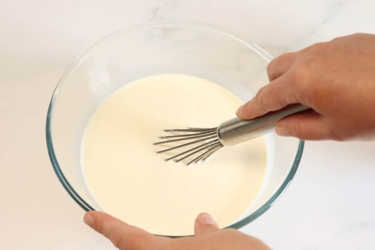 The cream, milk, vanilla extract and sugar is whisked in a bowl until the sugar is almost dissolved