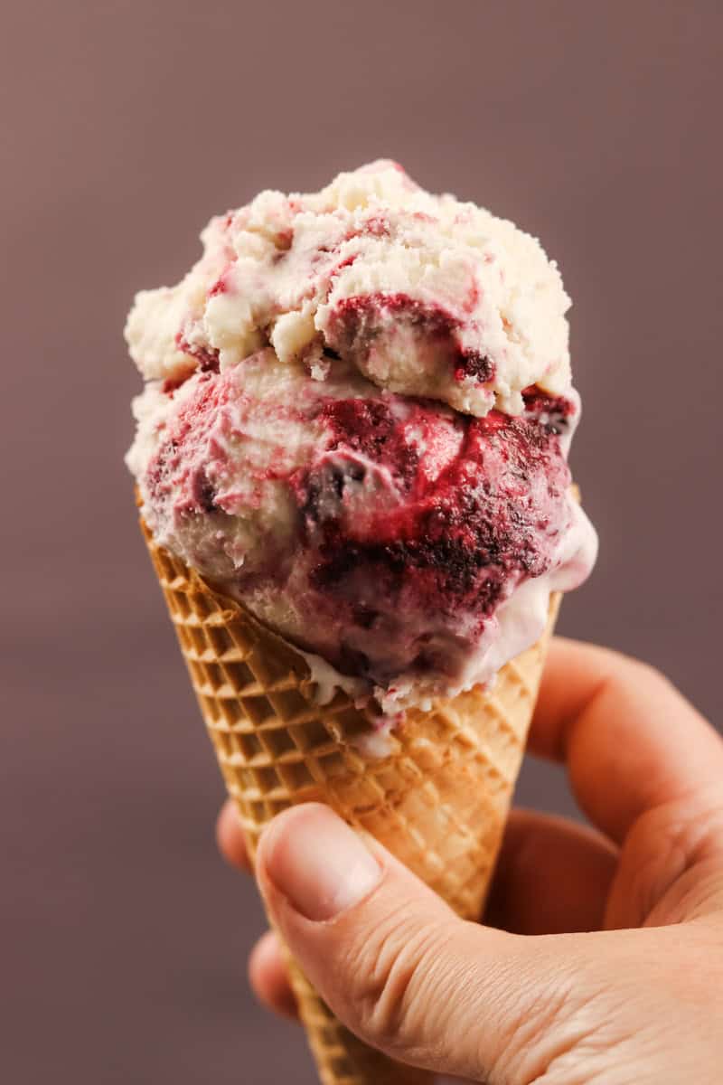 Homemade berry ice cream served in a waffle cone