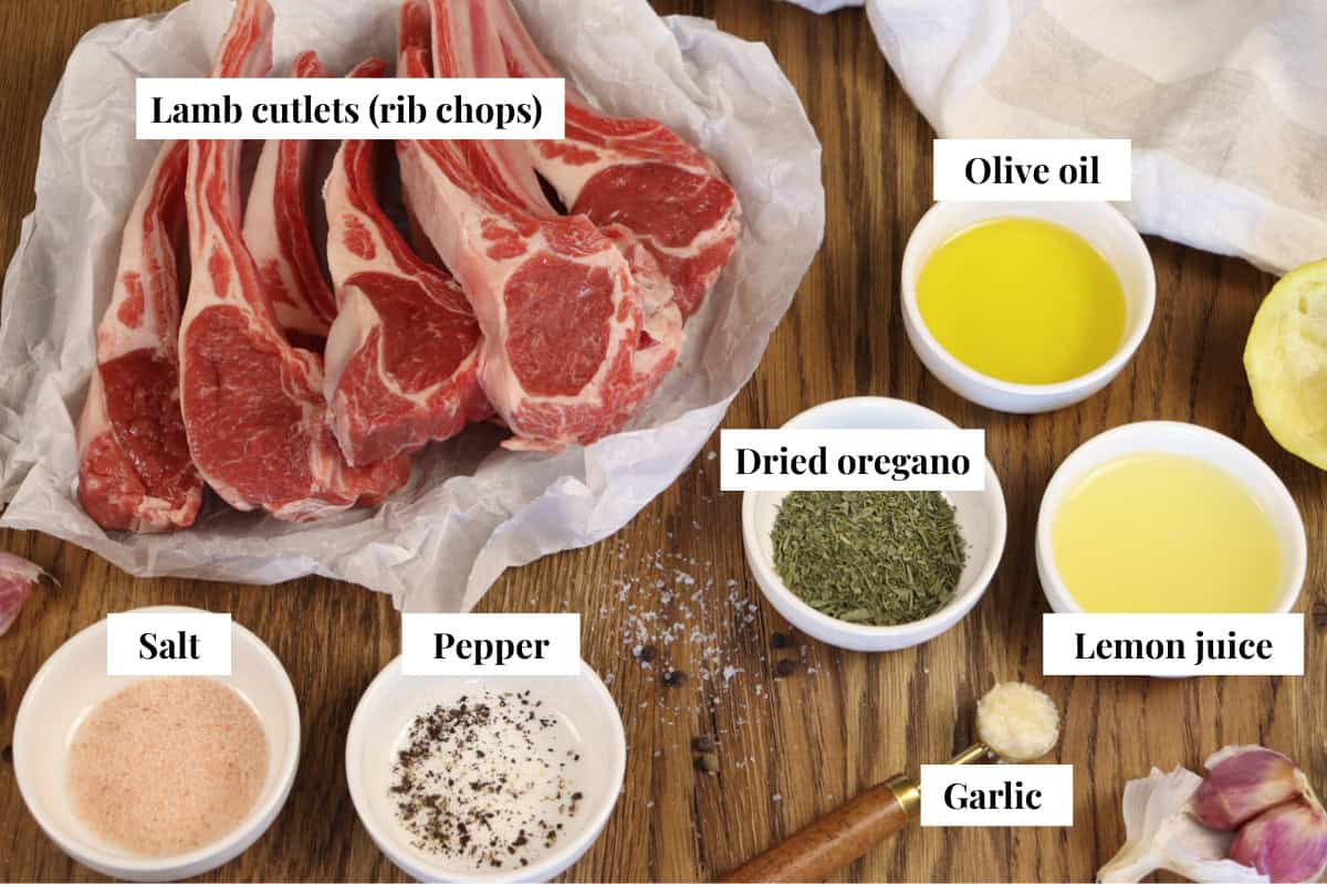 A graphic with an image of ingredients for air fryer lamb cutlets and text labels including lamb cutlets (rib chops), olive oil, dried oregano, lemon juice, garlic, salt and pepper