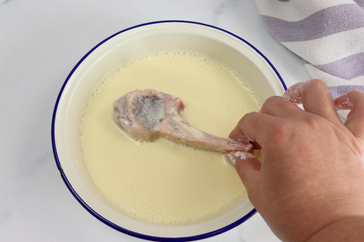 The lamb cutlets are dipped in the egg wash