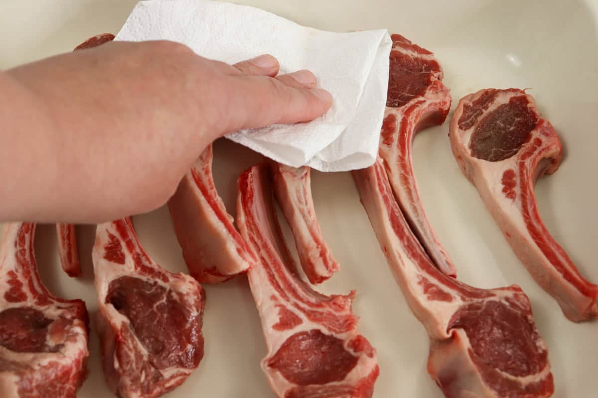 Before crumbing the lamb cutlets are dried with paper towel