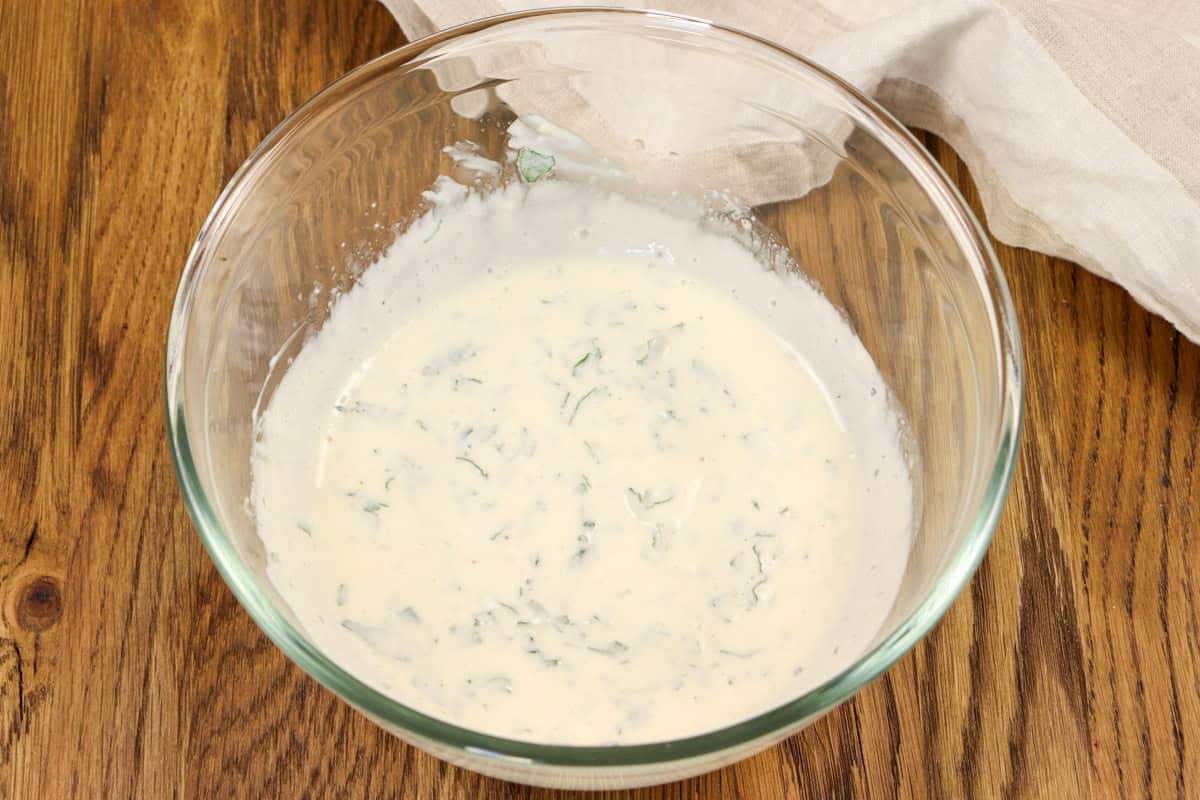 Mint and lamb sauce in a mixing bowl after been made