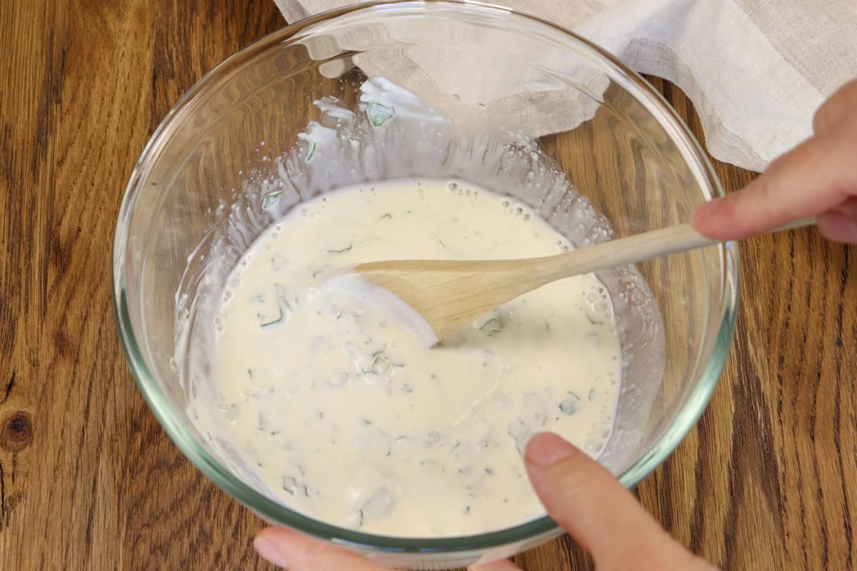Stirring the mint, yogurt, lemon juice and garlic